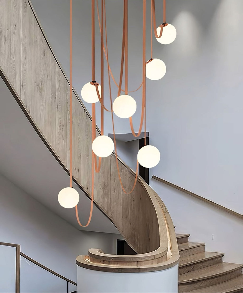 Multiple Belt Art Pendant Light glass globes lit close-up