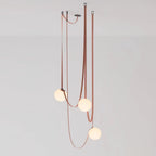 Multiple Belt Art Pendant Light lit globes in an evening interior