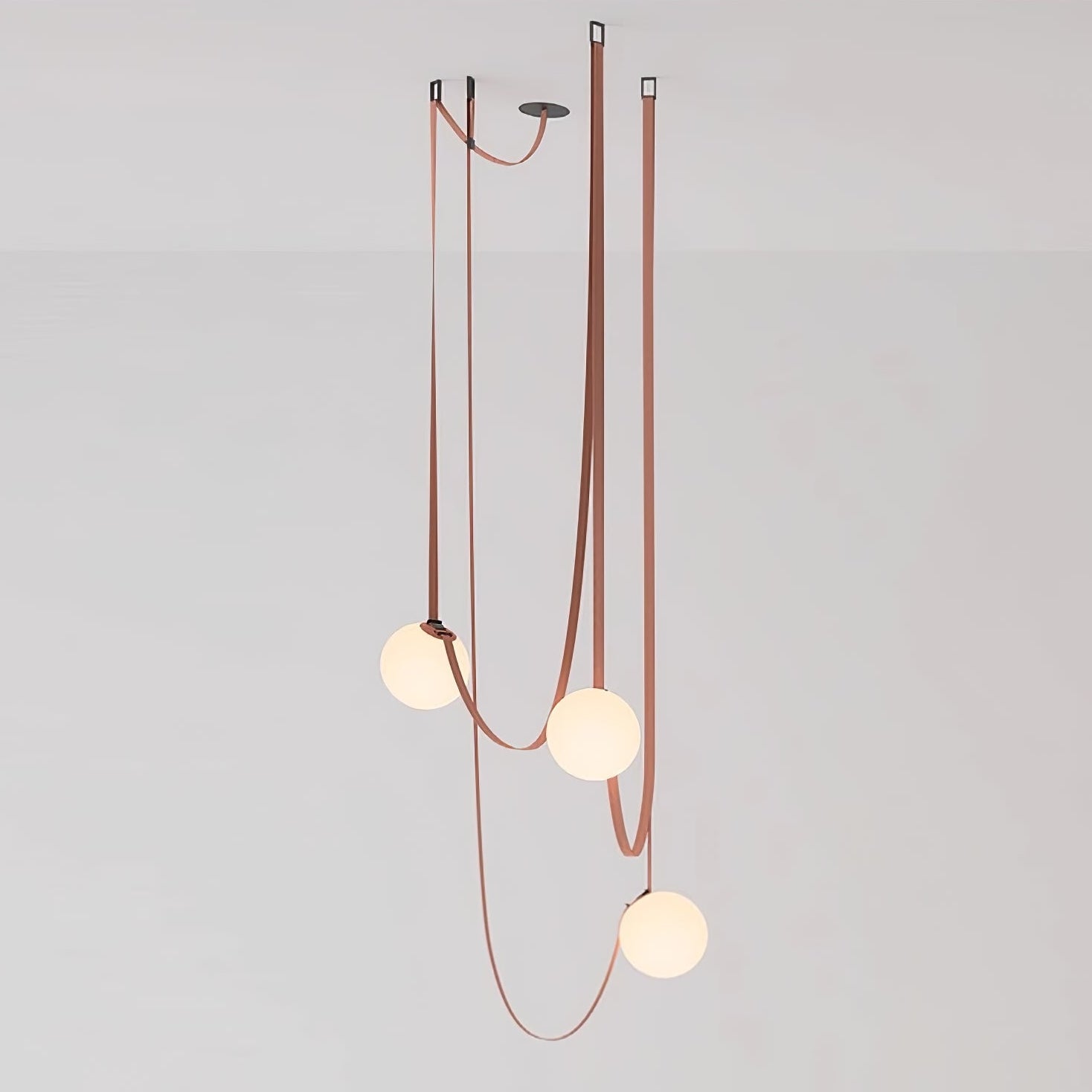 Multiple Belt Art Pendant Light lit globes in an evening interior