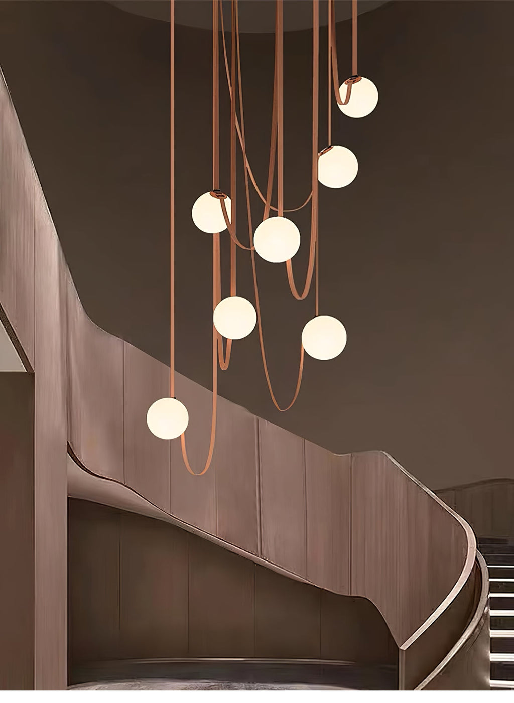 Multiple Belt Art Pendant Light glowing white globes in a dim room