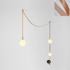 Leather belt and glass globe single-head detail of the pendant light