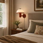 Dark oak mushroom wall lamp glowing softly above a living room sofa