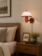 Mushroom wood wall lamp styled above a console table in a living space