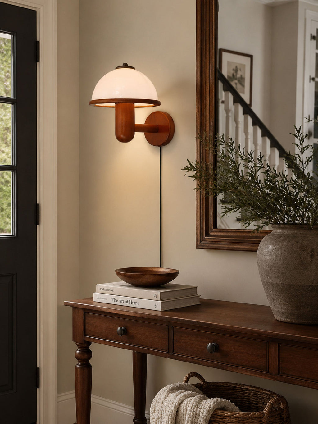 Mushroom wall lamp with white shade illuminating a cozy corner