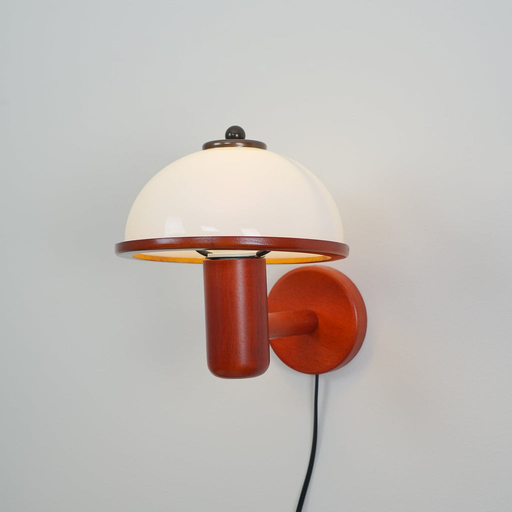 Oak mushroom wall lamp casting a warm pool of light on the wall