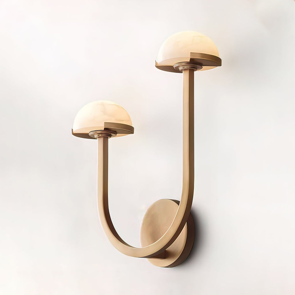 Brass Vitalira Double Alabaster Wall Light lit and floating against a soft white studio background.