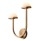 Vitalira Double Alabaster Wall Light in brass lit on white, the taller arm rising to the right.
