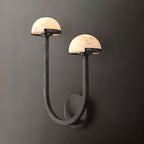 Vitalira Double Alabaster Wall Light in black lit against a charcoal backdrop, both domes glowing.