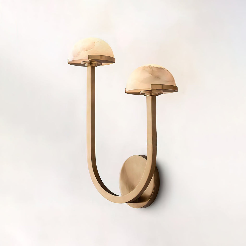 Vitalira Double Alabaster Wall Light in brass lit on a pale backdrop, seen from slightly below.
