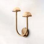 Vitalira Double Alabaster Wall Light in brass lit on a pale backdrop, seen from slightly below.