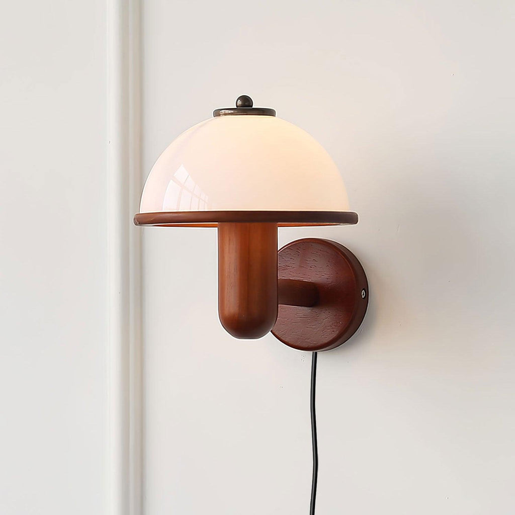 Mushroom wall lamp with inline switch cord on a light wall