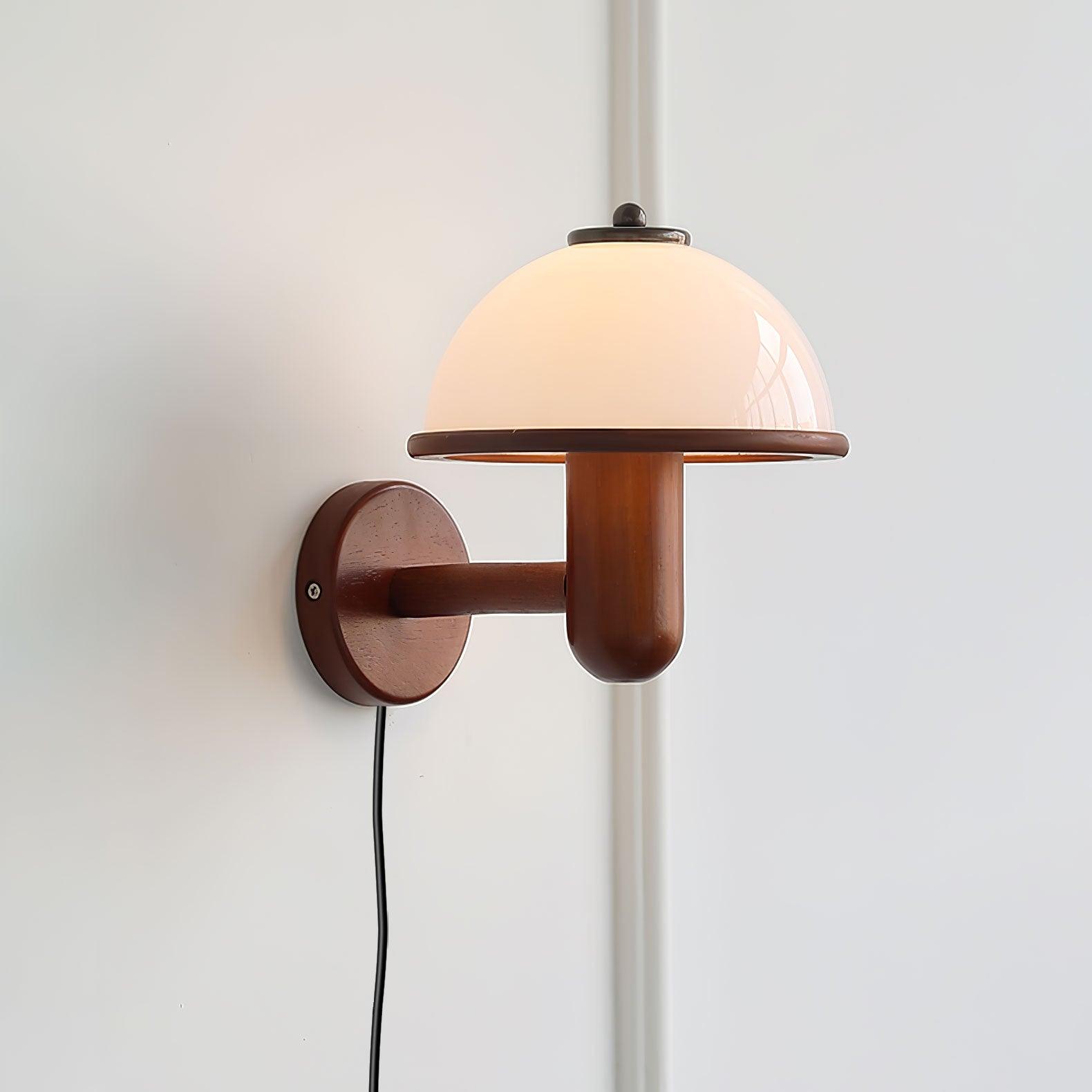 Dark oak mushroom wall lamp mounted above a chair in a reading nook