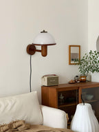 Mushroom wall lamp glowing softly near a window