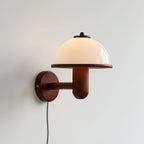 Mushroom wall lamp lighting a wall above a wooden sideboard
