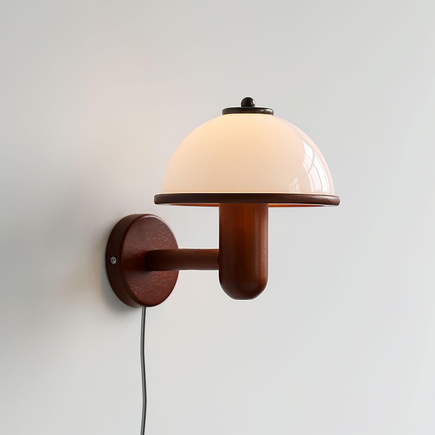 Mushroom wall lamp lighting a wall above a wooden sideboard