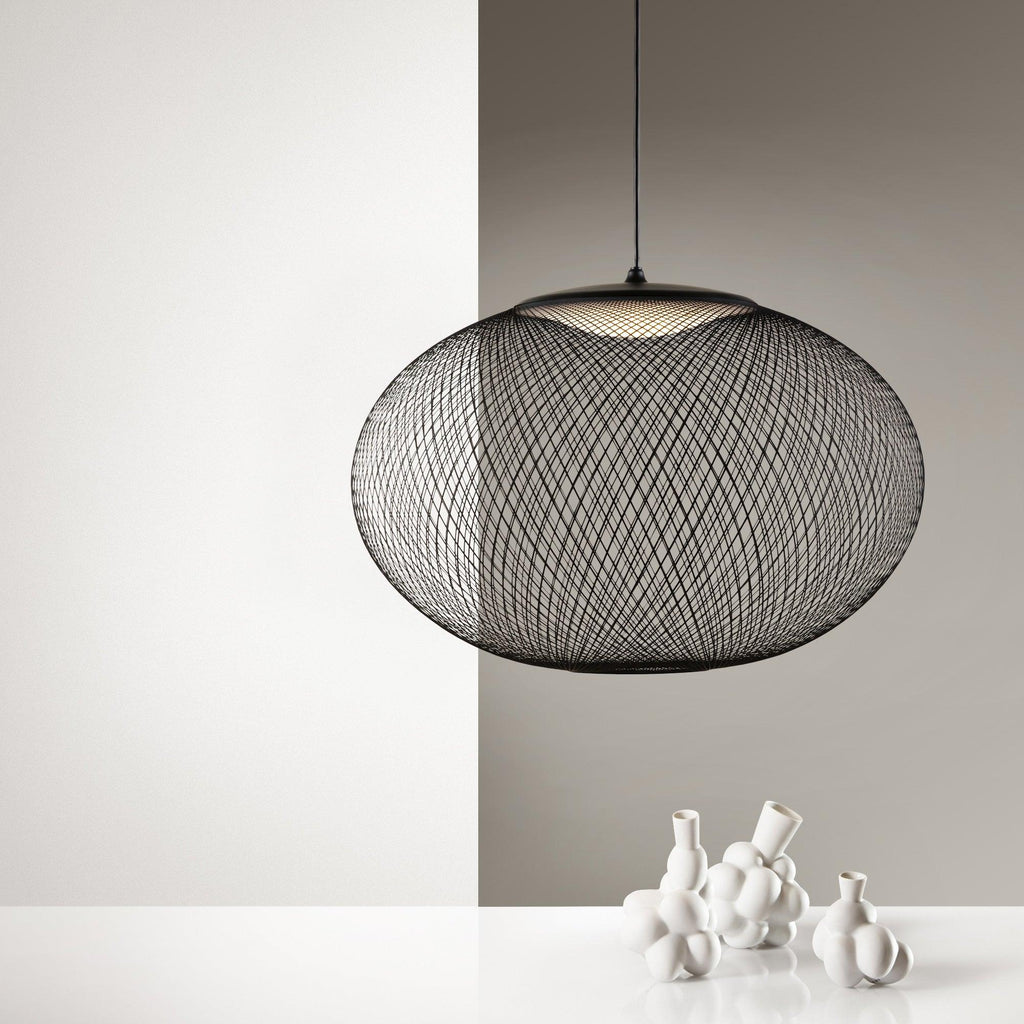 Mesh pendant light glowing softly in a warm room
