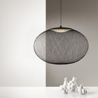 Mesh pendant light glowing softly in a warm room