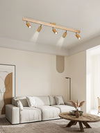 Track spotlight with natural wood shades lighting a wall