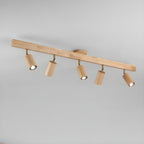 Track spotlight with walnut wood shades against a wall