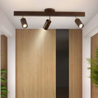 Natural wood spotlight heads angled across a ceiling