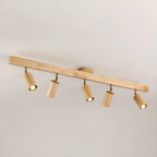 Wood track spotlight with adjustable heads glowing warmly