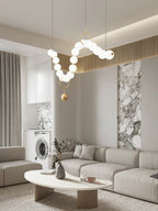 Necklace pendant light string of white globes lit warm
