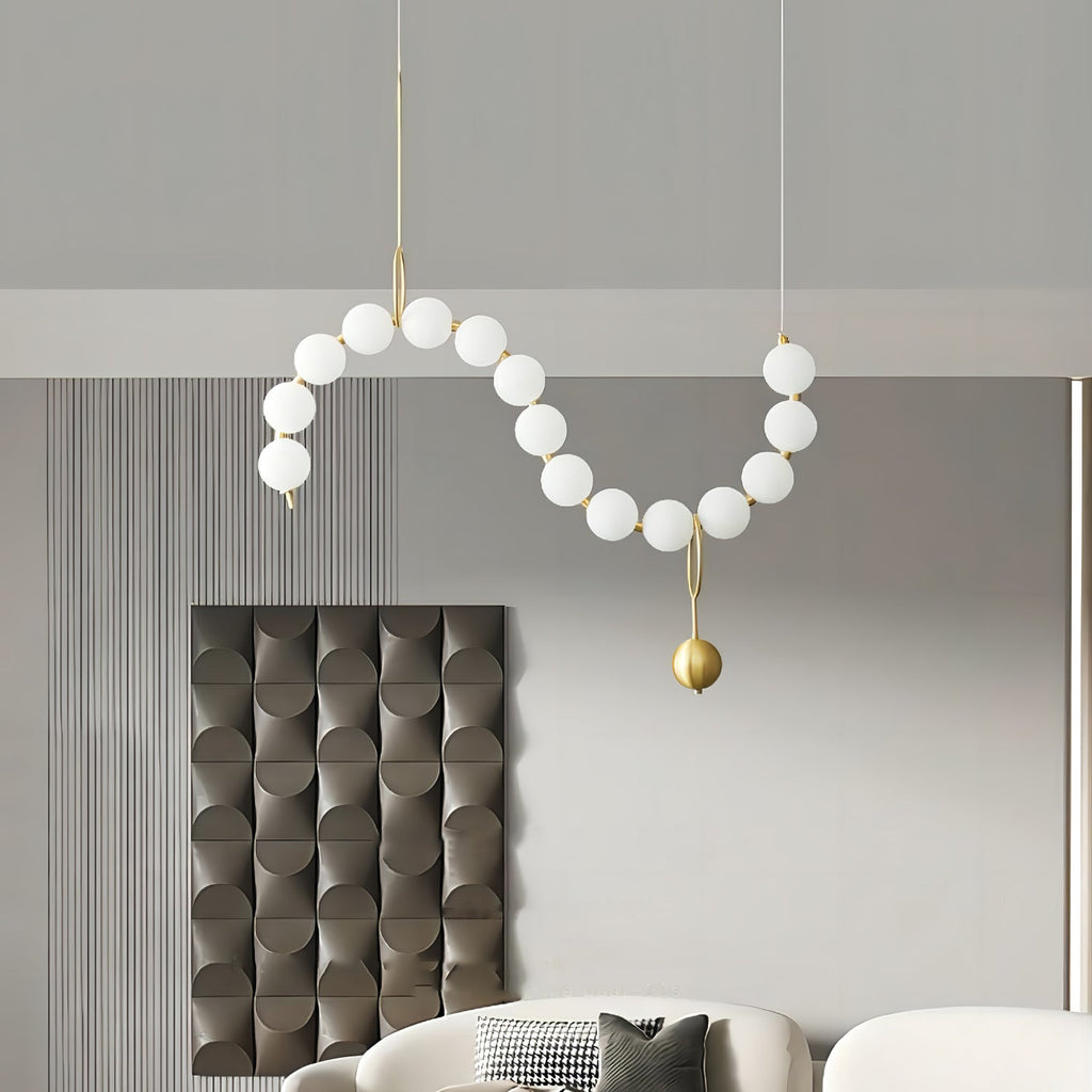 Necklace pendant light arranged along a long surface