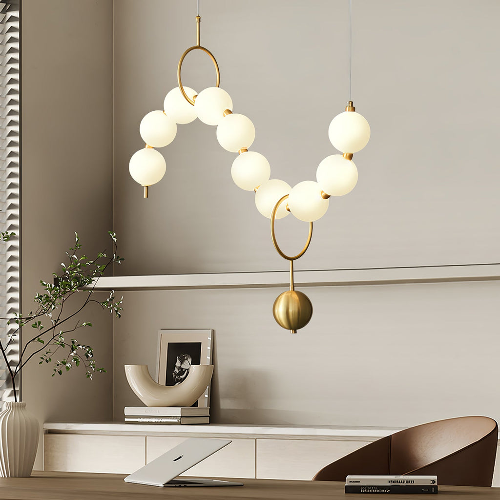 Necklace pendant light curved into a graceful arc of globes