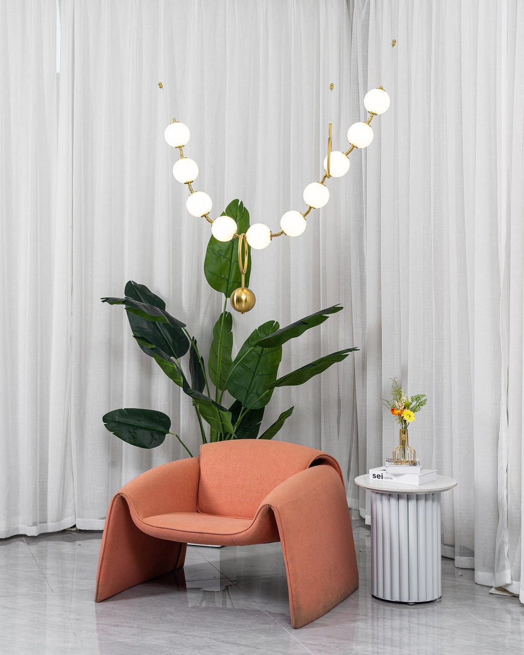Necklace pendant light suspended over a dining space
