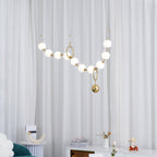 Necklace pendant light with luminous glass globes overhead