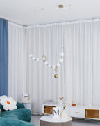 Necklace pendant light glowing in a warm interior setting