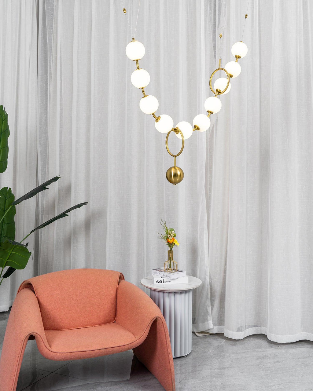 Necklace pendant light with white globes glowing in a row
