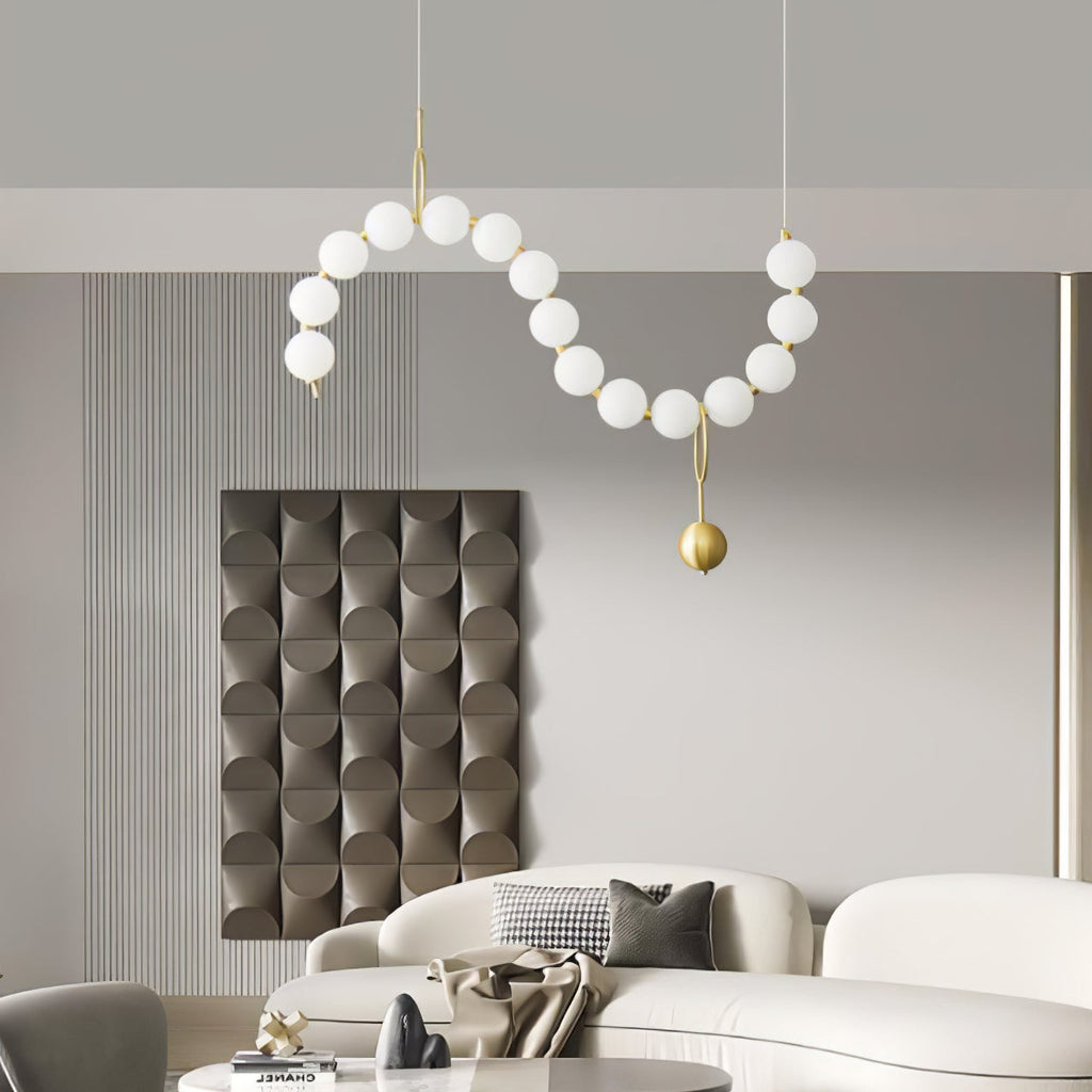 Necklace pendant light shown glowing above a room