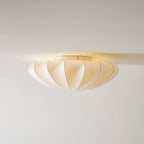 Nelson Bubble ceiling lamp shown lit, the silk diffusing warm ambient light