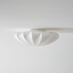 Nelson Bubble ceiling lamp shown lit, the silk diffusing warm ambient light