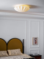 Nelson Bubble ceiling lamp with a silk cover over a steel wireframe casting a soft glow