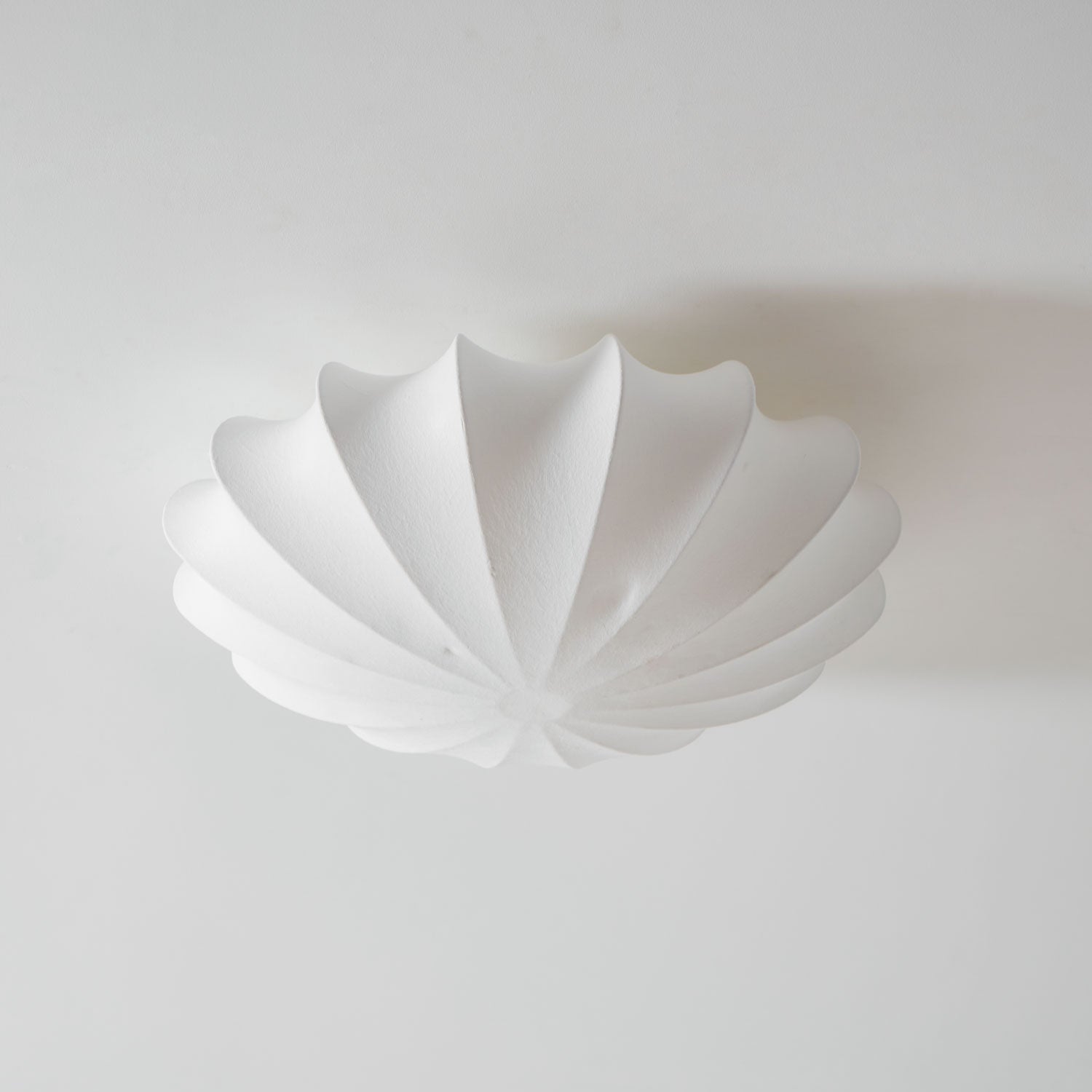Nelson Bubble ceiling lamp with a silk cover over a steel wireframe casting a soft glow