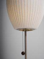 Chrome-stemmed faux silk bubble table lamp glowing in a cosy living room