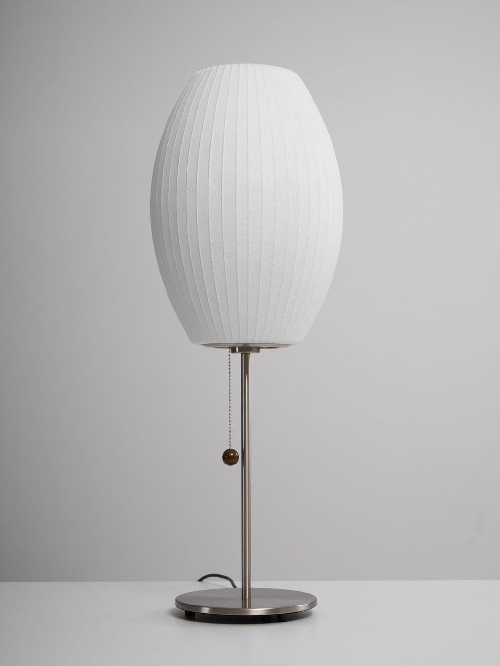 Close detail of the faux silk bubble shade's soft texture and curved form