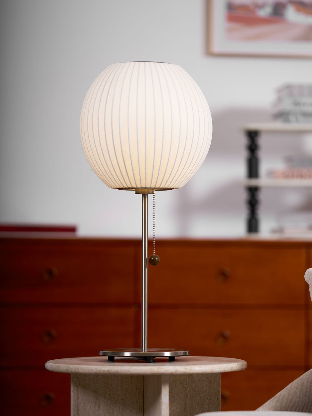Side profile of the faux silk bubble table lamp and round chrome base