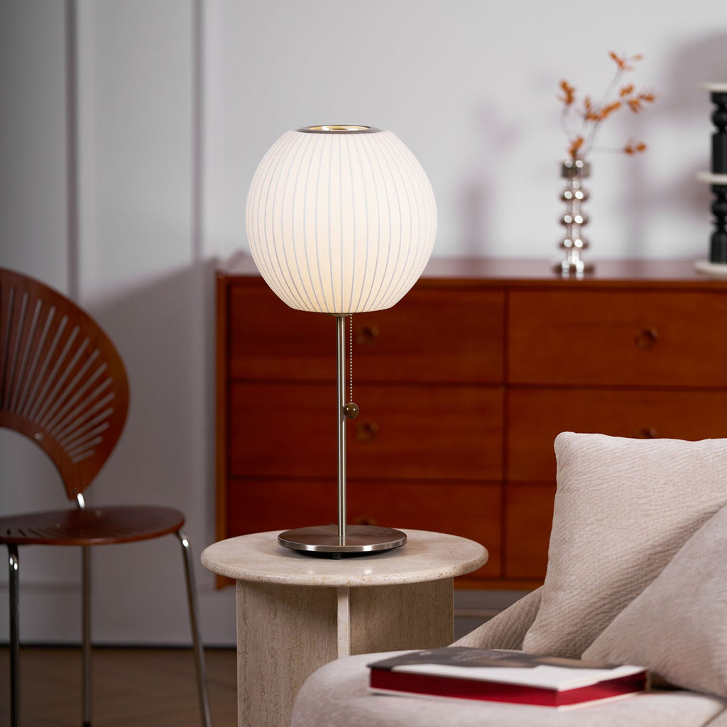 Side profile of the faux silk bubble table lamp and round chrome base