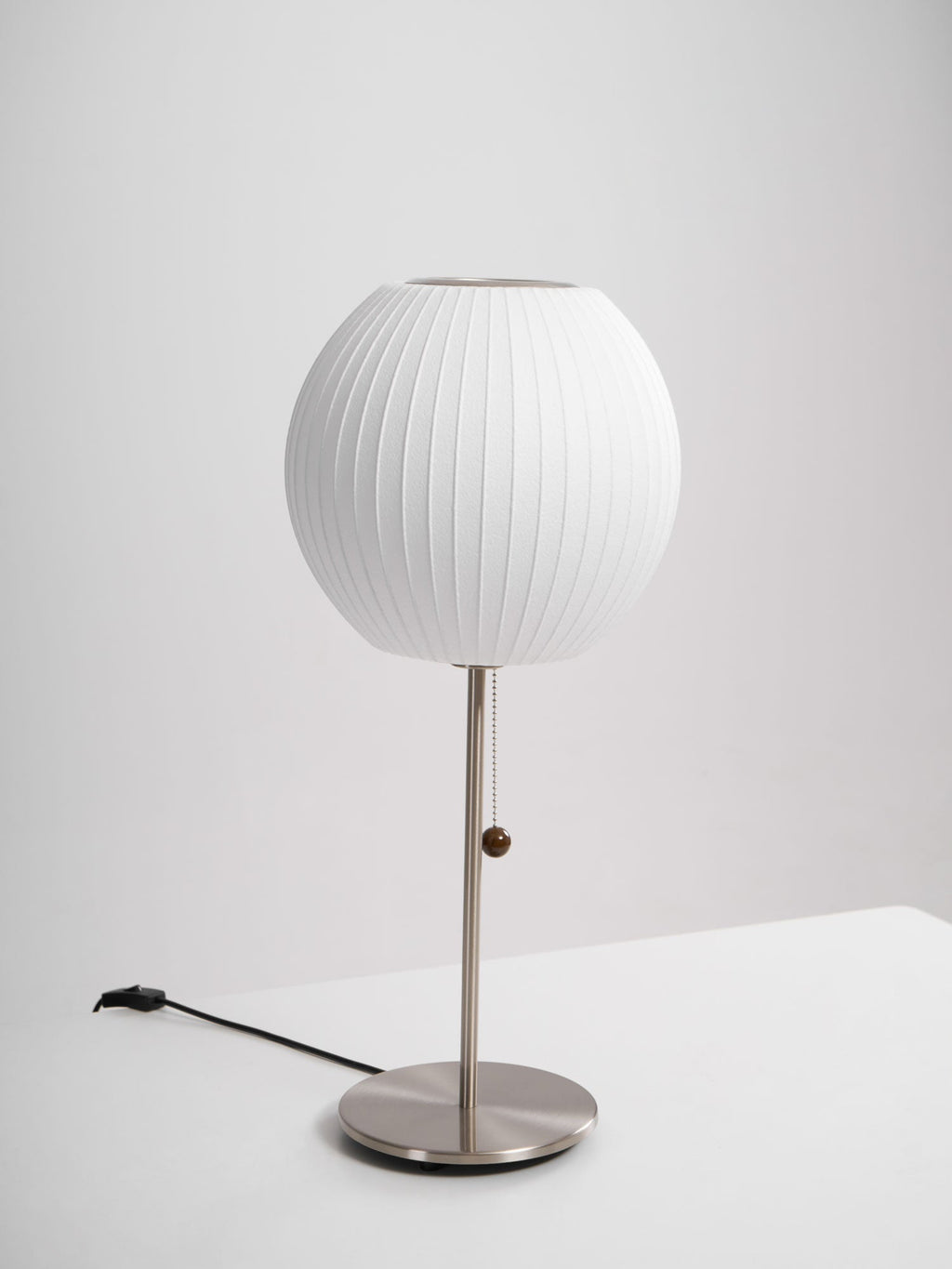 Faux silk bubble table lamp on a bedside table casting a soft diffused glow