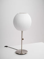 Faux silk bubble table lamp on a bedside table casting a soft diffused glow