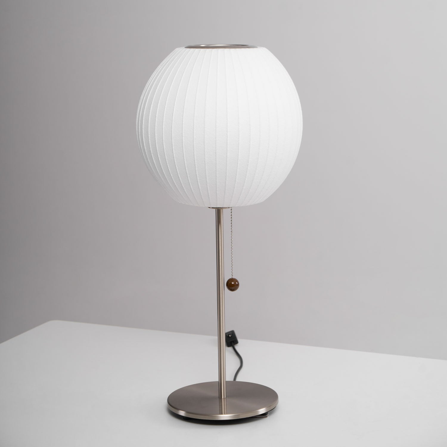 Close detail of the faux silk bubble shade's soft texture and curved form