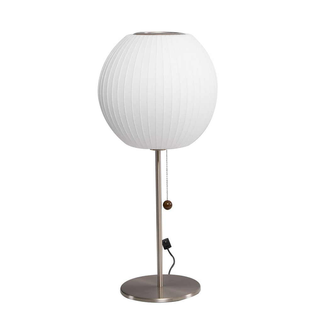 Chrome-stemmed faux silk bubble table lamp glowing in a cosy living room