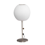Chrome-stemmed faux silk bubble table lamp glowing in a cosy living room