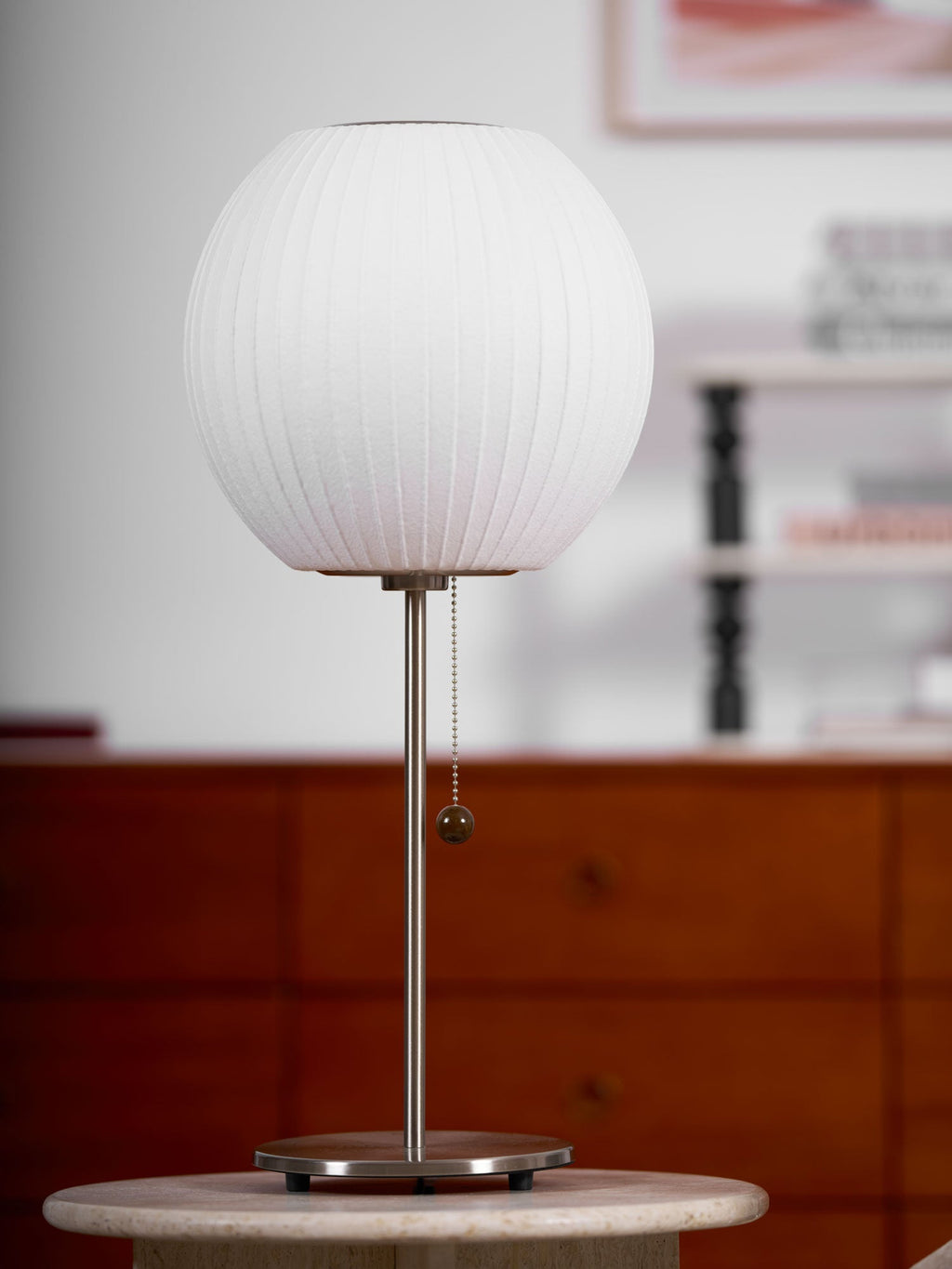 Side profile of the faux silk bubble table lamp and round chrome base