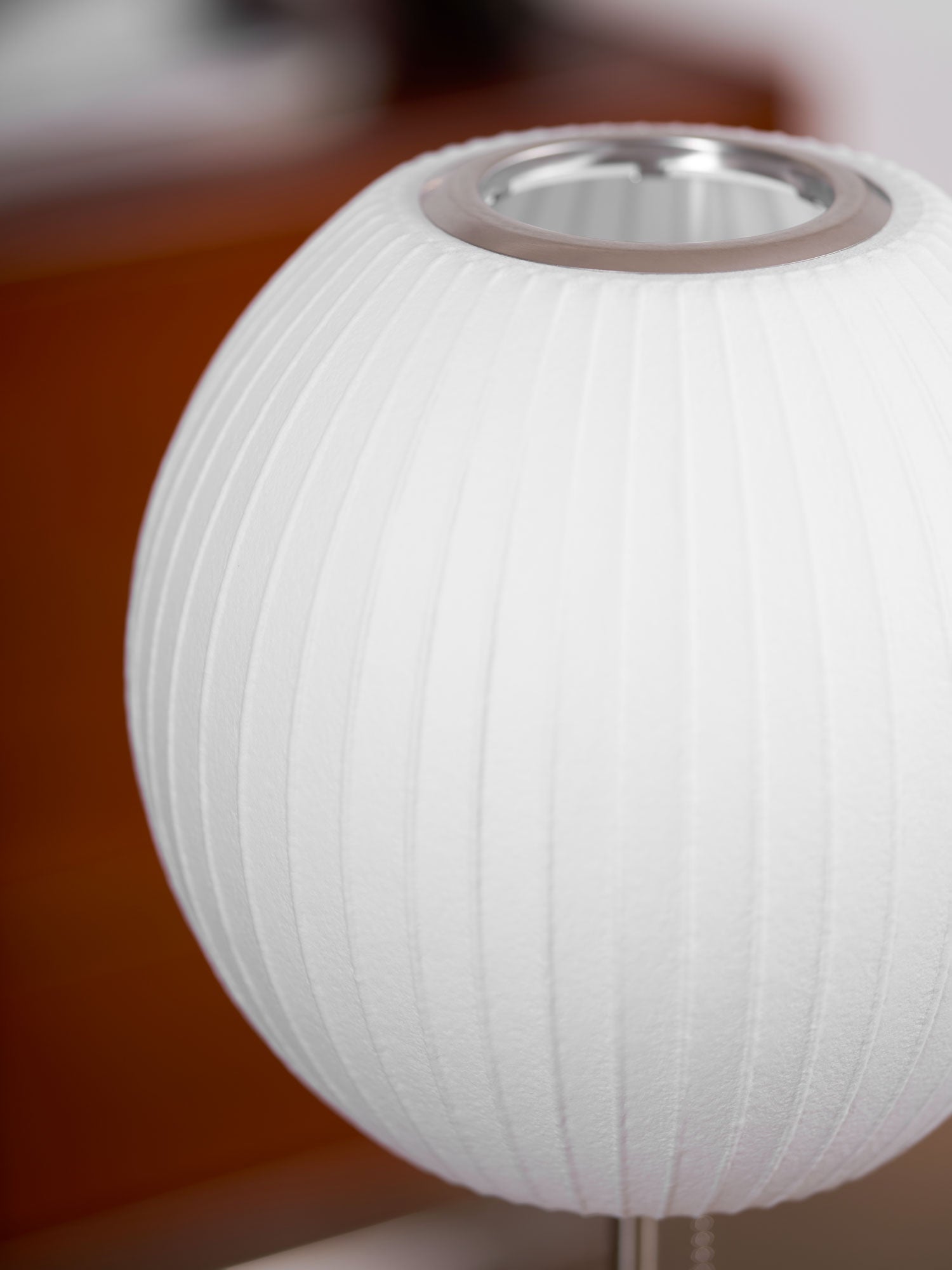 Faux silk bubble table lamp on a bedside table casting a soft diffused glow