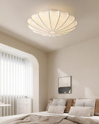 Nelson Bubble ceiling lamp shown lit, the silk diffusing warm ambient light