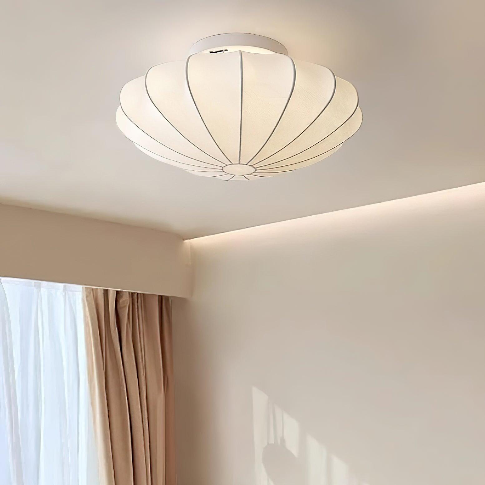 Nelson Bubble ceiling lamp shown lit, the silk diffusing warm ambient light